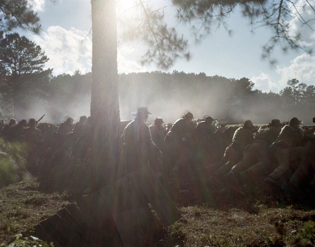 Confederate reenactors fight from behind earthworks in Resaca, 2014
