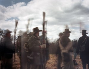 Confederate reenactors raise their rifles in a sign of capitulation at the 150th anniversary of the Battle of Sailor's Creek in Rice, Virginia 2015